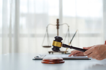 Judge holding gavel in courtroom making decision