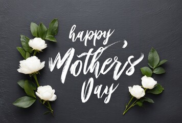 White handwritten 'Happy Mothers Day' text with delicate white flowers and green leaves arranged on a textured dark gray background