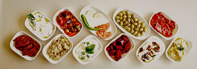 Delicious meat kebab with fresh vegetable salad served with variety of Turkish dishes and appetizers. Top view of assorted Turkish food and meze, tasty and healthy Mediterranean cuisine. Top view.