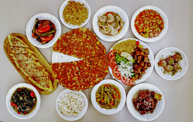 Delicious meat kebab with fresh vegetable salad served with variety of Turkish dishes and appetizers. Top view of assorted Turkish food and meze, tasty and healthy Mediterranean cuisine. Top view.