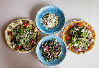 Delicious meat kebab with fresh vegetable salad served with variety of Turkish dishes and appetizers. Top view of assorted Turkish food and meze, tasty and healthy Mediterranean cuisine. Top view.