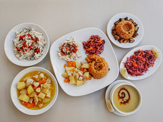 Delicious meat kebab with fresh vegetable salad served with variety of Turkish dishes and appetizers. Top view of assorted Turkish food and meze, tasty and healthy Mediterranean cuisine. Top view.