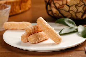 Traditional Glutinous Rice Sticks with Snowflake Sugar Coating - Beijing Chinese Dessert on White Plate