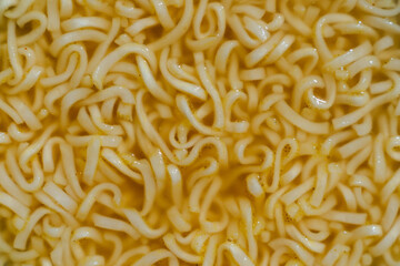 Yellow quick noodles in broth, ramen close-up