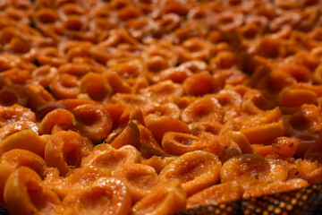Apricot slices are dried in the sun in a drying net, outdoor summer