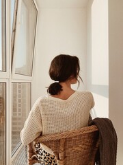 Obraz na płótnie Canvas Woman in Sweater Sitting by Window
