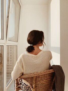 Fototapeta Woman in Sweater Sitting by Window