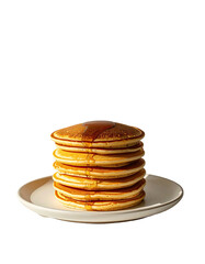 Stack of golden brown pancakes drizzled with syrup on a white plate
