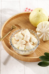 Fresh White Guava Slices in Crystal Bowl on Wooden Tray - Soft Cream Gallery Style from Guangxi