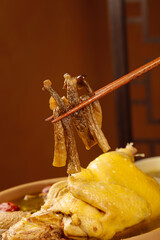 Mother Hen and Old Stewed Yam Chicken Soup with Chopsticks - Traditional Chinese Comfort Food