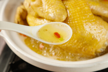 Homemade Chicken Soup with Yam and Vegetables - Traditional Nourishing Stewed Hen Broth in Bowl