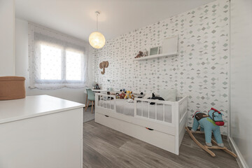 Modern bedroom with single bed, folding study table, and built-in storage bench