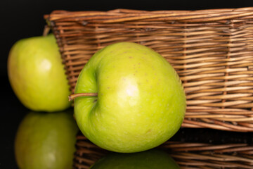 Juicy green apples isolated on black background, close-up.