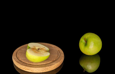 Juicy green apples isolated on black background, close-up.