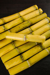 Golden Yellow Sugar Cane Stalks from Yunnan Displayed on Black Table