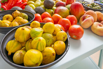 Still life photography of bananas, pears, avocados, potatoes, nectarines, and figs showing different stages 