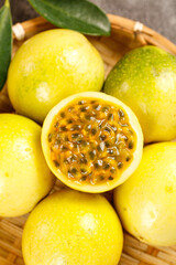 Fresh Golden Yellow Passion Fruits in Basket - Tropical Exotic Fruit with Pulp and Seeds
