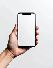A hand holds a sleek, black, modern smartphone with a blank white screen against a bright white backdrop, creating a clean, minimalist aesthetic