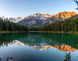 Calm lake reflecting snow-capped mountains and lush forest under a bright sky. The serene landscape evokes peace and natural beauty
