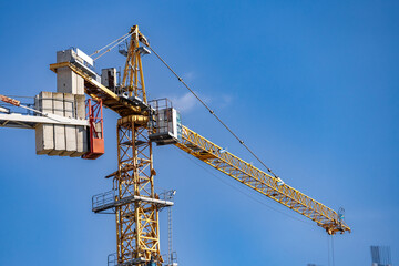 Tower crane at construction. Modern crane. Equipment for construction and lifting large-sized loads with construction materials. Construction equipment.
