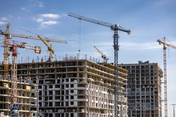 Tower Crane on building construction. Construction crane on Housing. Construction site, Multi Storey Residential Buildings construction. Formworks. Modern Townhome building. Modern House building.