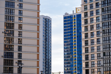 Modern residential building. View to a quiet city block with tall buildings in the evening