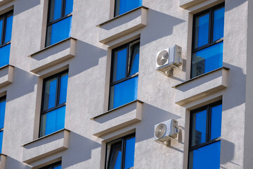 Modern Building Exterior with Air Conditioning. Sun Reflection in Window