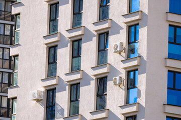 Modern luxury residential flat. Modern apartment building on a sunny day. Apartment building with a blue sky. Facade of a modern apartment building.