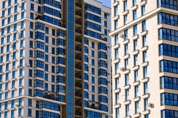 Part of Modern residential apartment with flat building exterior. Detail of New luxury house and home complex. Fragment of City Real estate property and condo architecture. Copy space. Blue sky