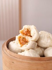Traditional Chinese Xiaolongbao Soup Dumplings in Bamboo Steamer with Savory Pork Filling