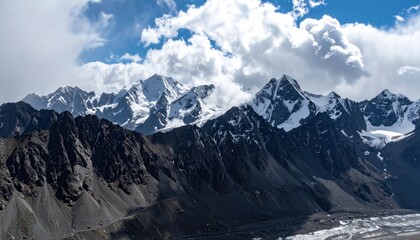 Majestic mountains reach skyward under a dramatic cloudscape, showing rocky terrain transitioning to snow-capped peaks, offering a serene vista