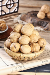 Fresh Xinjiang Walnuts in Bamboo Basket on Traditional Chinese Paper - Healthy Organic Nuts and Dried Fruits Display