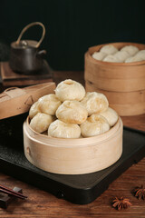 Traditional Chinese Xiaolongbao Soup Dumplings in Bamboo Steamers with Tea Set