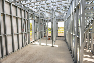 Light gauge steel framing system used for house construction. Wall to be clad with fibre cement board. Metal frame of newly built building. Construction of a new tiny house