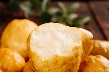Fresh Cut Pear Slices with Juicy White Flesh on Rustic Wood Background