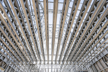 New technology steel frame for construction. Metal frame of the building with a sandwich panel of insulation on the wall. Construction of a new industrial building.