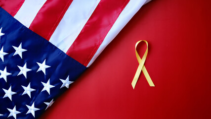A yellow ribbon on a red background with an American flag for Suicide Prevention Awareness Month