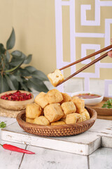 Crispy Fried Tofu Puffs in Wicker Basket with Chopsticks - Traditional Asian Food Display