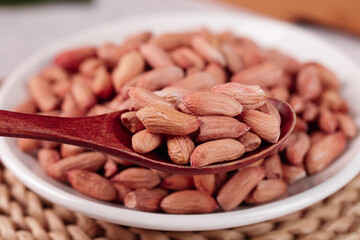 Shandong Red Skinned Peanuts Yako Variety in Bowl with Wooden Spoon