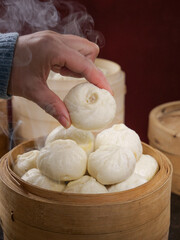 Traditional Chinese Xiaolongbao Soup Dumplings in Bamboo Steamer - Fresh Steamed Dim Sum Buns