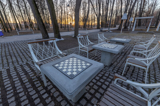 A park with a checkered table and chairs