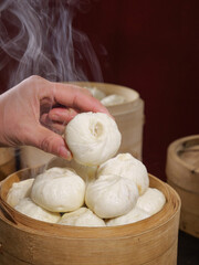 Traditional Chinese Xiaolongbao Soup Dumplings in Bamboo Steamer Basket with Steam