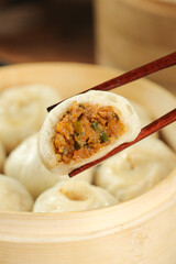 Traditional Chinese Xiaolongbao Soup Dumplings with Meat Filling in Bamboo Steamer Basket
