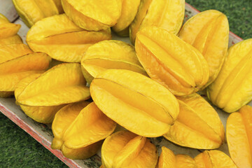 Fresh Ripe Yellow Star Fruit Slices at Market Display Showing Natural Pentagram Shape