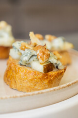 crispy crostini topped with fresh pear slices and creamy blue cheese. Perfect for illustrating elegant fall appetizers, holiday party snacks