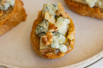 crispy crostini topped with fresh pear slices and creamy blue cheese. Perfect for illustrating...
