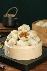 Traditional Chinese Xiaolongbao Soup Dumplings with Meat Filling in Bamboo Steamer Basket