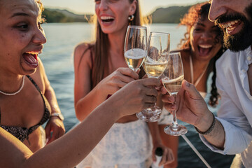 Friends celebrating and toasting with champagne on boat
