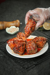 Spicy Shuangliu Rabbit Head Dish - Traditional Chinese Cold Appetizer with Chef's Hand