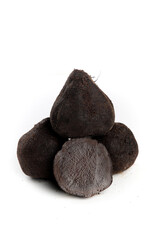 Black truffles on white background with cut truffle showing interior texture